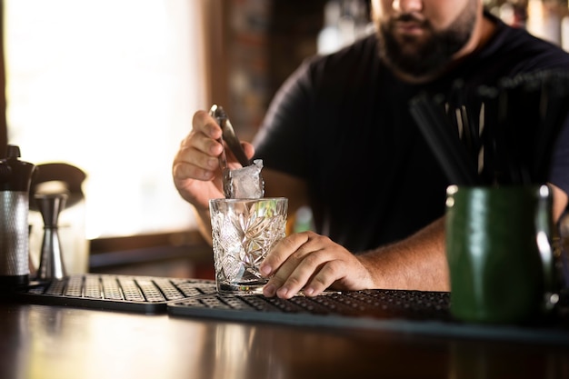 Close up on bartender creating delicious drink