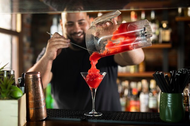 Close up on bartender creating delicious drink