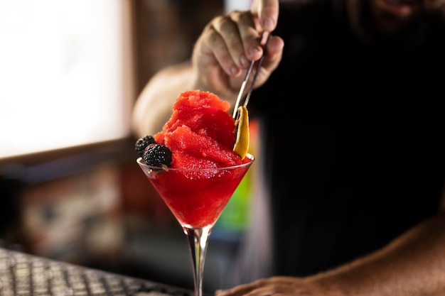 Close up on bartender creating delicious drink