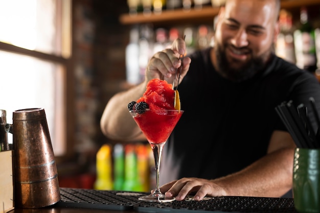 Close up on bartender creating delicious drink