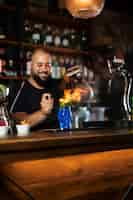 Free photo close up on bartender creating delicious drink