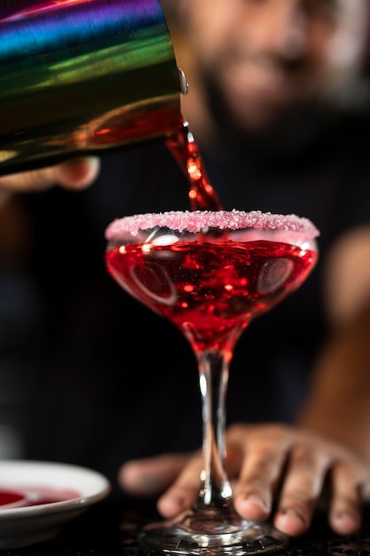 Close up on bartender creating delicious drink