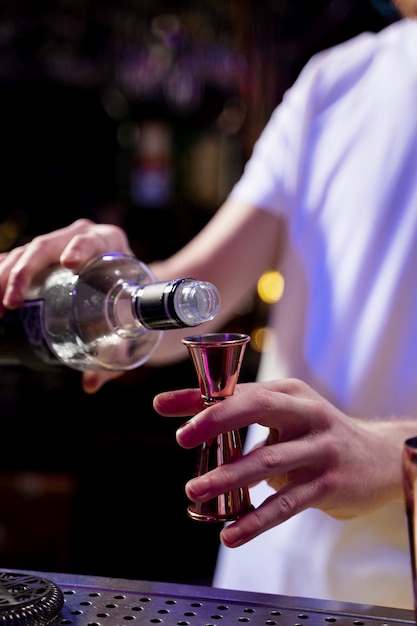 Close up bartender making drink