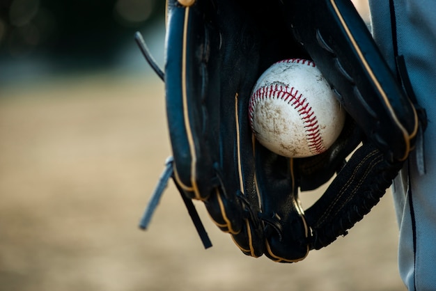 Close-up of baseball held in glove