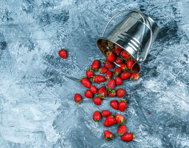 Close-up a basket of strawberries on dark blue marble background. horizontal