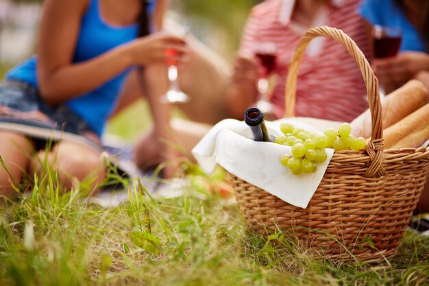 Close-up of basket with grapes and wine