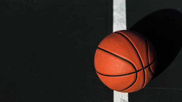 Close up of basketball on court Free Photo