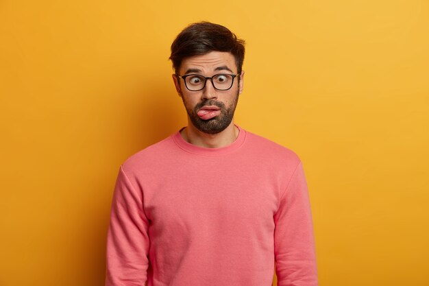 Close up on bearded young man wearing glasses isolated