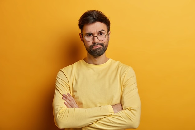 Close up on bearded young man wearing glasses isolated