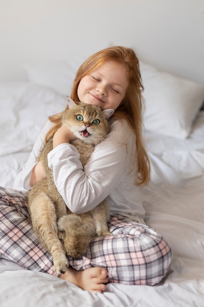 Close up on beautiful cat with little girl