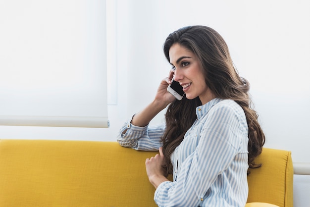 Close-up of beautiful employee talking on the phone