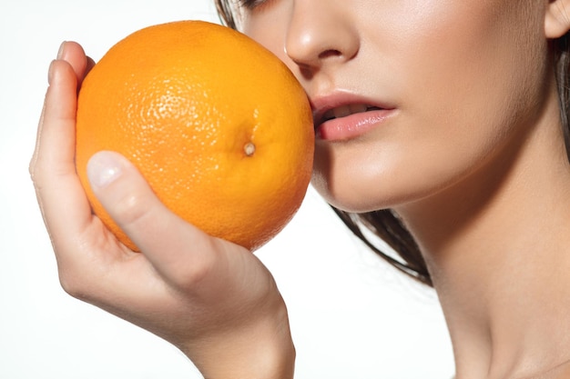 Close up of beautiful female face with organic treatment over white background.