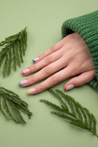 Close up beautiful manicure and leaves