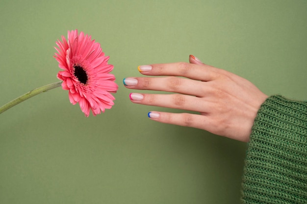 Close up beautiful manicure and pink flowers