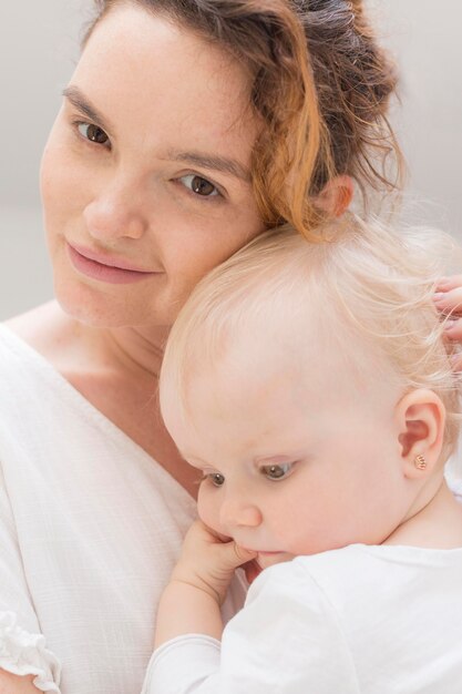 Close-up beautiful mother holding baby girl