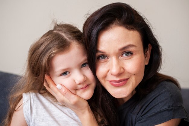 Close-up beautiful mother and young daughter