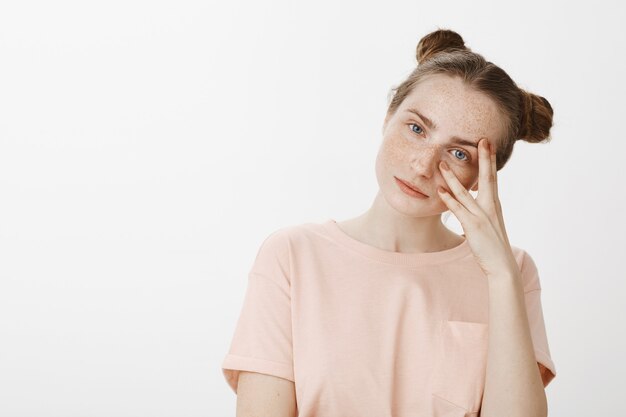 Close-up of beautiful teenage girl posing against the white wall