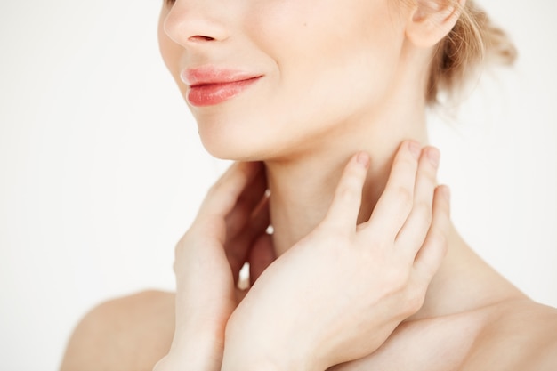 Close up of beautiful tender girl with clean healthy skin smiling . Facial treatment.