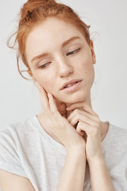 Close up of beautiful tender redhead woman posing smiling dreaming.