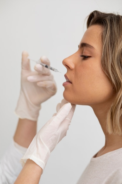 Close up beautiful woman getting lip filler