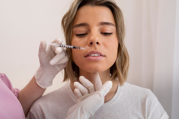 Close up beautiful woman getting lip filler