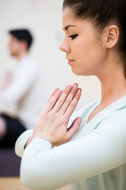 Close-up of beautiful woman sitting in lotus position