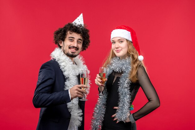 Close up on beautiful young couple wearing Santa hats isolated