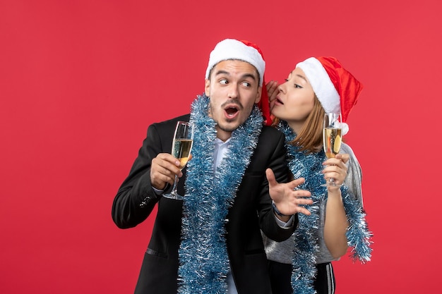 Close up on beautiful young couple wearing santa hats isolated