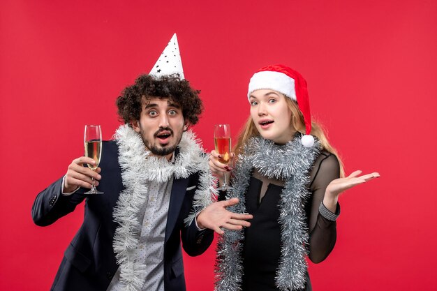 Close up on beautiful young couple wearing Santa hats isolated