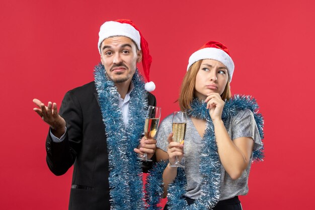 Close up on beautiful young couple wearing Santa hats isolated