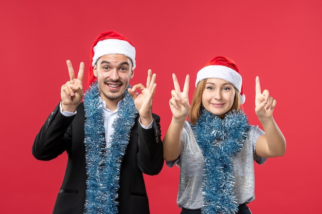 Close up on beautiful young couple wearing Santa hats isolated