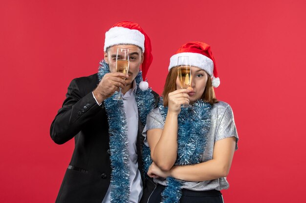 Close up on beautiful young couple wearing Santa hats isolated