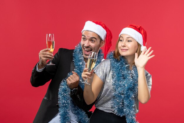 Close up on beautiful young couple wearing Santa hats isolated