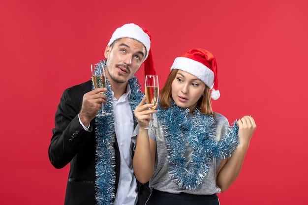 Close up on beautiful young couple wearing Santa hats isolated