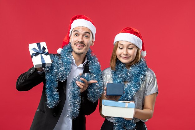 Close up on beautiful young couple wearing Santa hats isolated