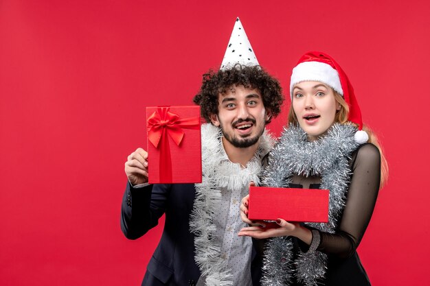 Close up on beautiful young couple wearing Santa hats isolated