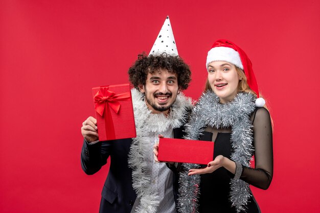 Close up on beautiful young couple wearing Santa hats isolated