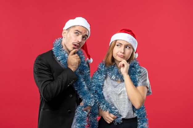 Close up on beautiful young couple wearing Santa hats isolated