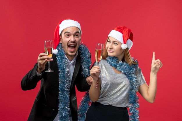 Close up on beautiful young couple wearing Santa hats isolated
