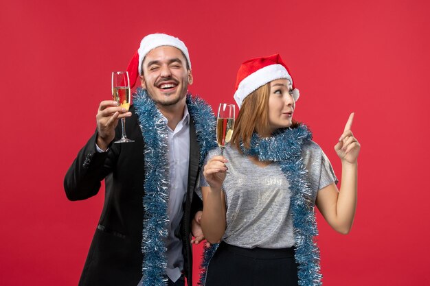 Close up on beautiful young couple wearing Santa hats isolated