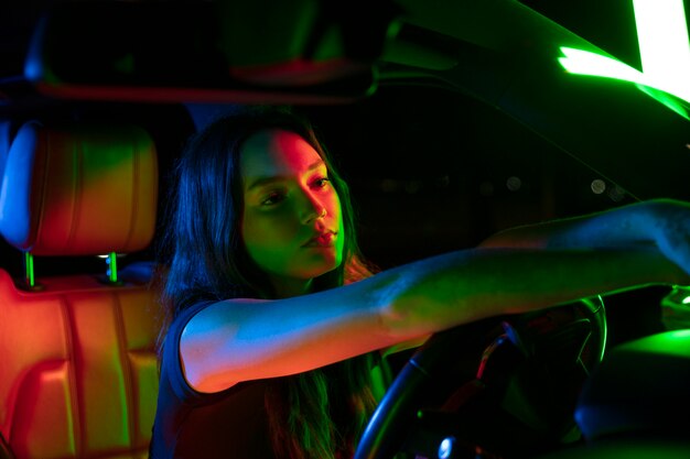 Close up on beautiful young woman driving