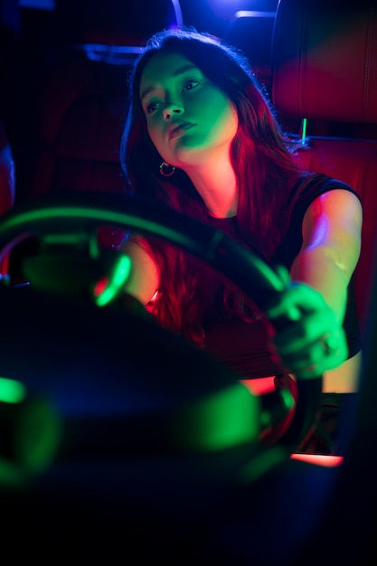 Free photo close up on beautiful young woman driving