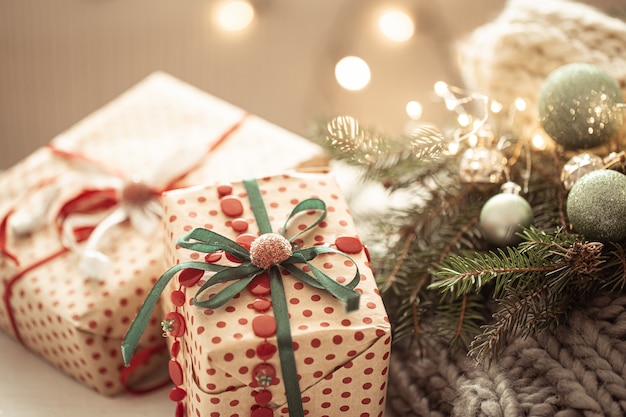 Close up of beautifully wrapped christmas gift on cozy blurred background