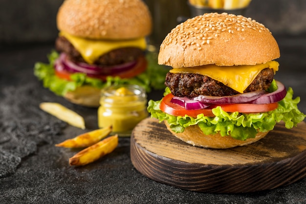 Close-up beef burgers on cutting board with sauce