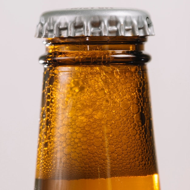 Close-up of a beer bottle with cap