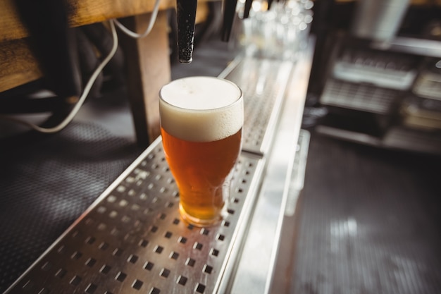 Close-up of beer glass with froth