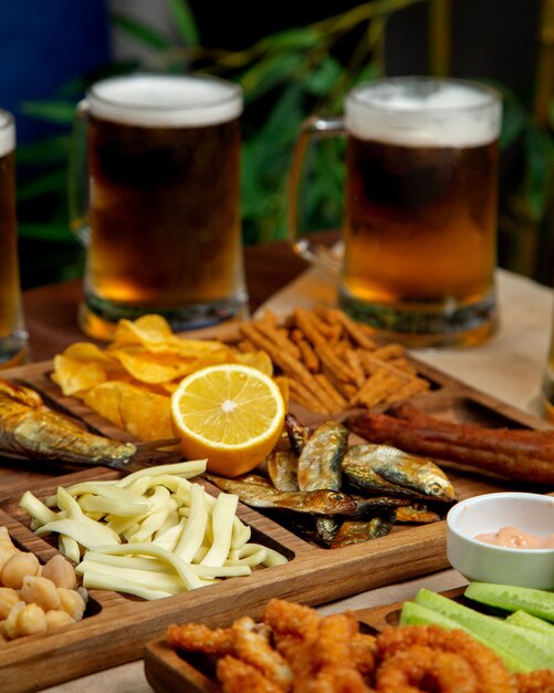 Close up of beer snacks platter with string cheese smoked herrings chickpeas chips