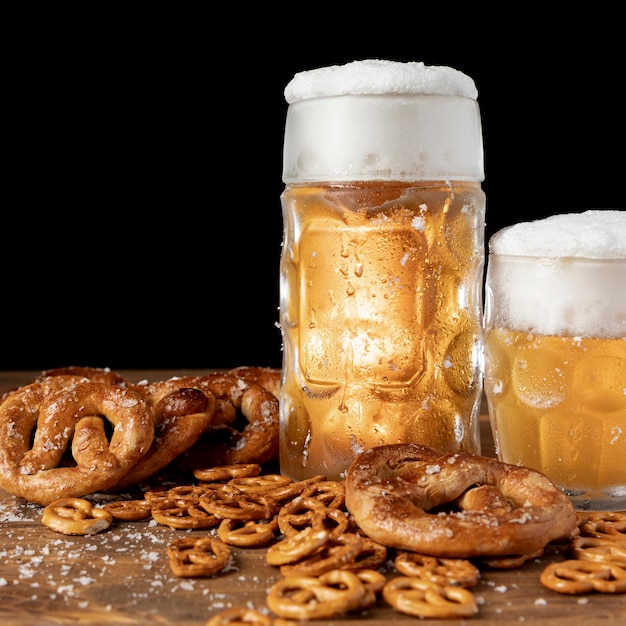 Close-up beer with foam and pretzels 