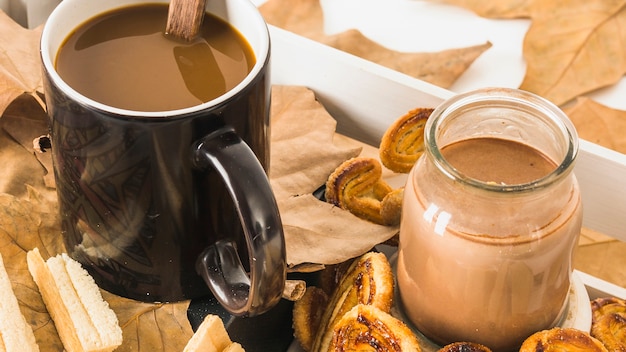 Close-up beverages near pastry and leaves