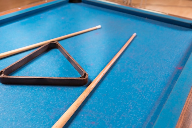 Close-up billiard table with cue sticks